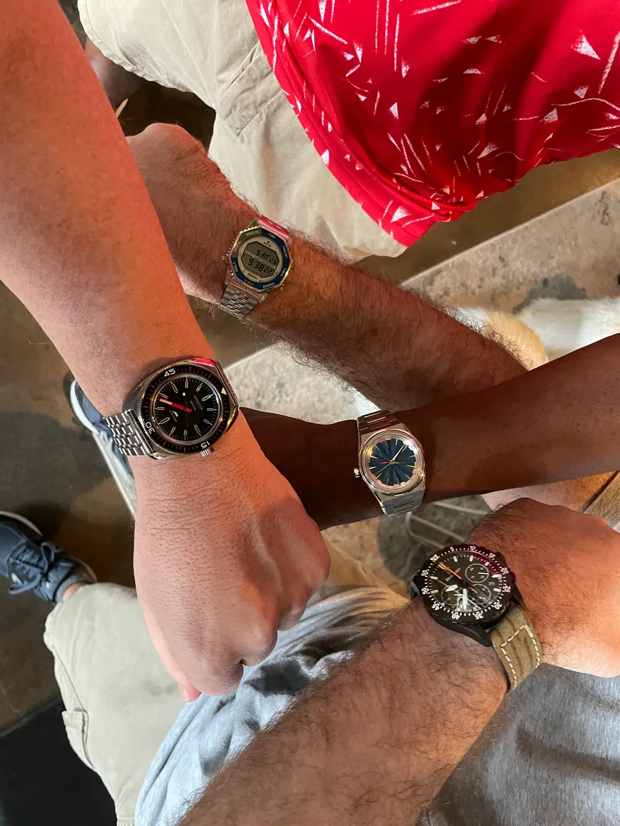 Friends' watches, wrists together